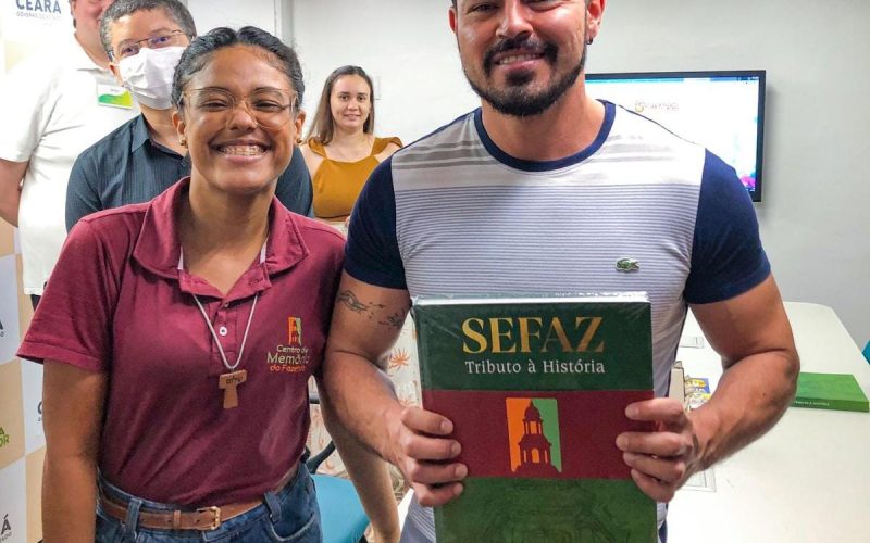 Sorteio do livro “Sefaz: tributo à história” como parte da visita ao Centro de Memória da Fazenda.